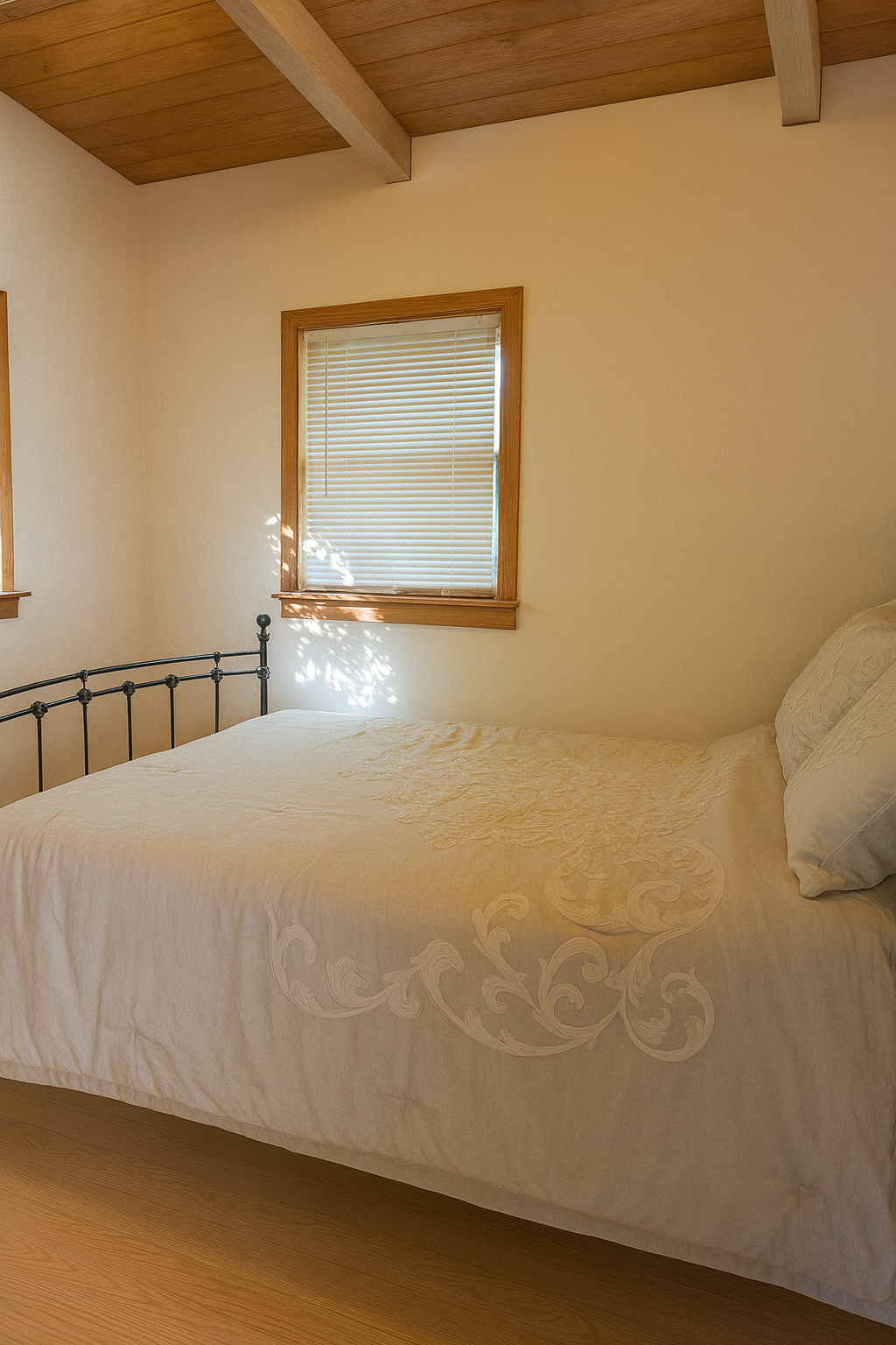 Cozy bedroom with exposed wood beam ceiling and comfortable bedding