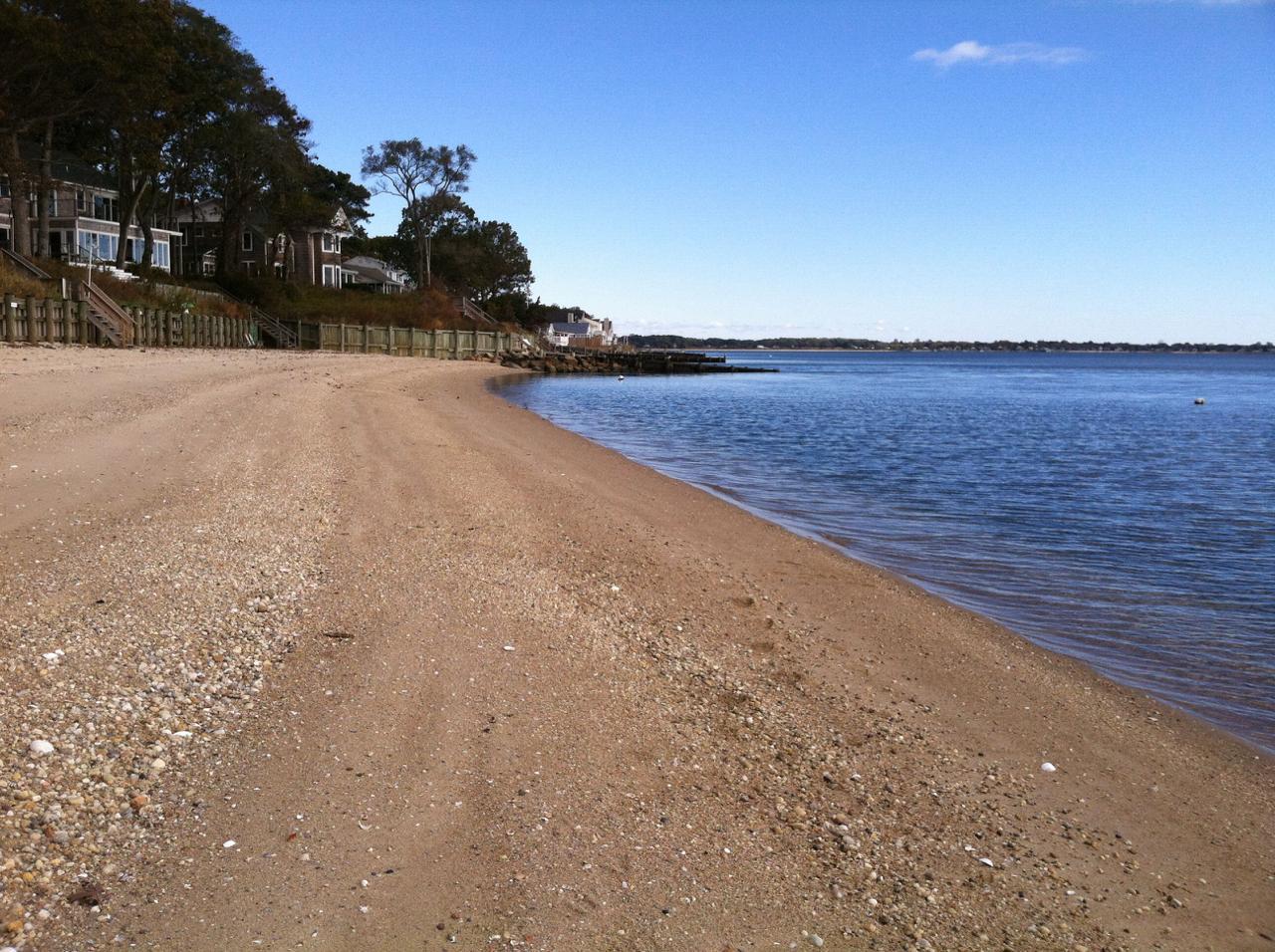 Pristine beach with charming houses on the bluff